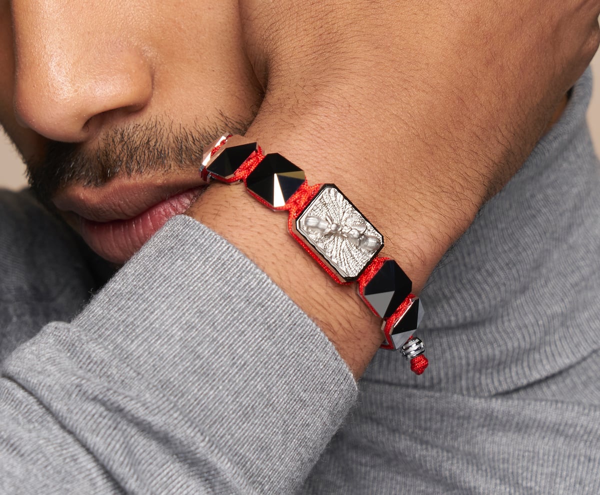 Proud Of You bracelet with ceramic and sculpture finished in a Platinum effect complemented with a red coloured cord.