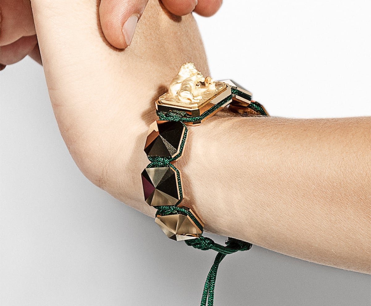 I Love Me bracelet with ceramic and sculpture finished in 18k Yellow Gold complemented with a green coloured cord.