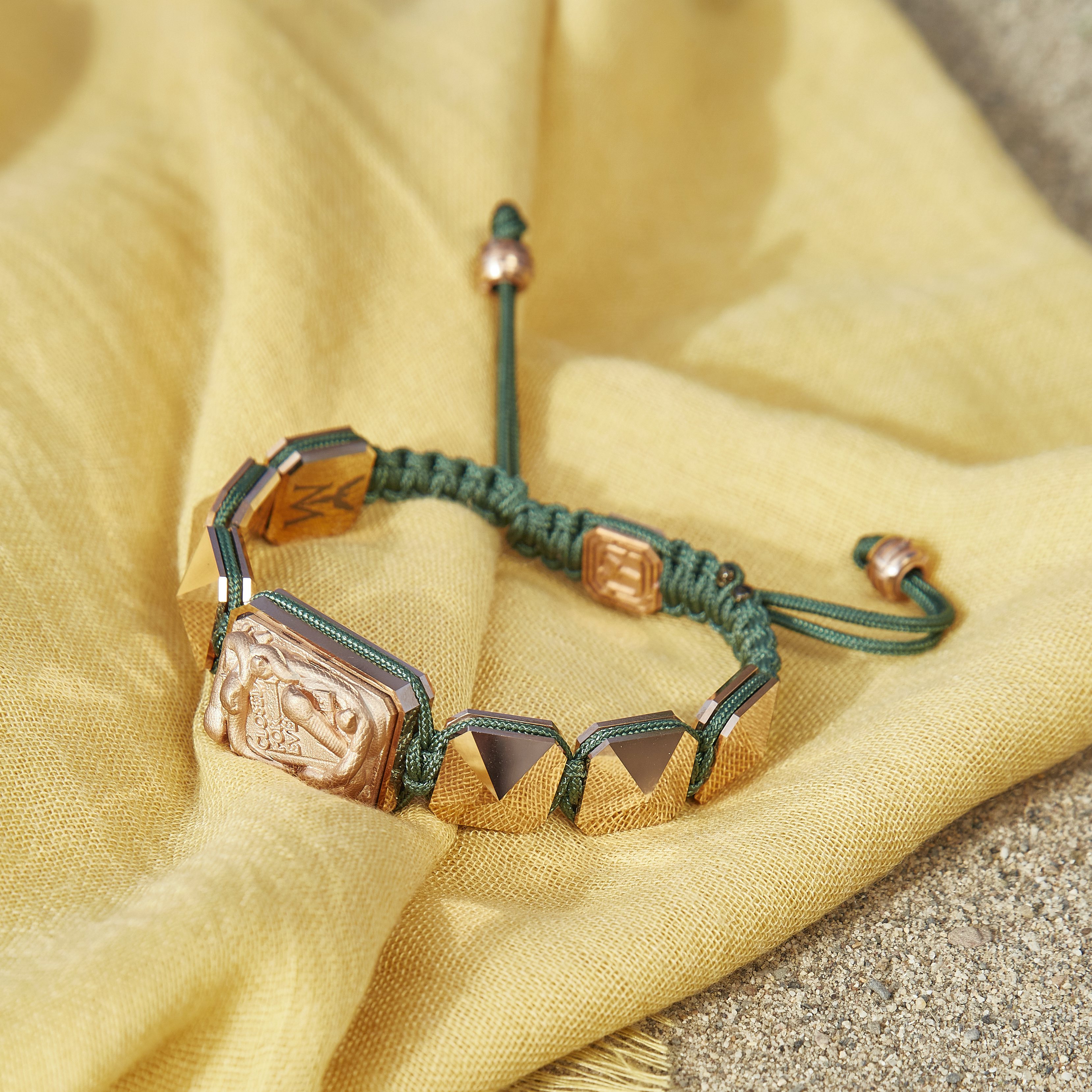 Miss You bracelet with ceramic and sculpture finished in 18k Rose Gold complemented with a dark green coloured cord.