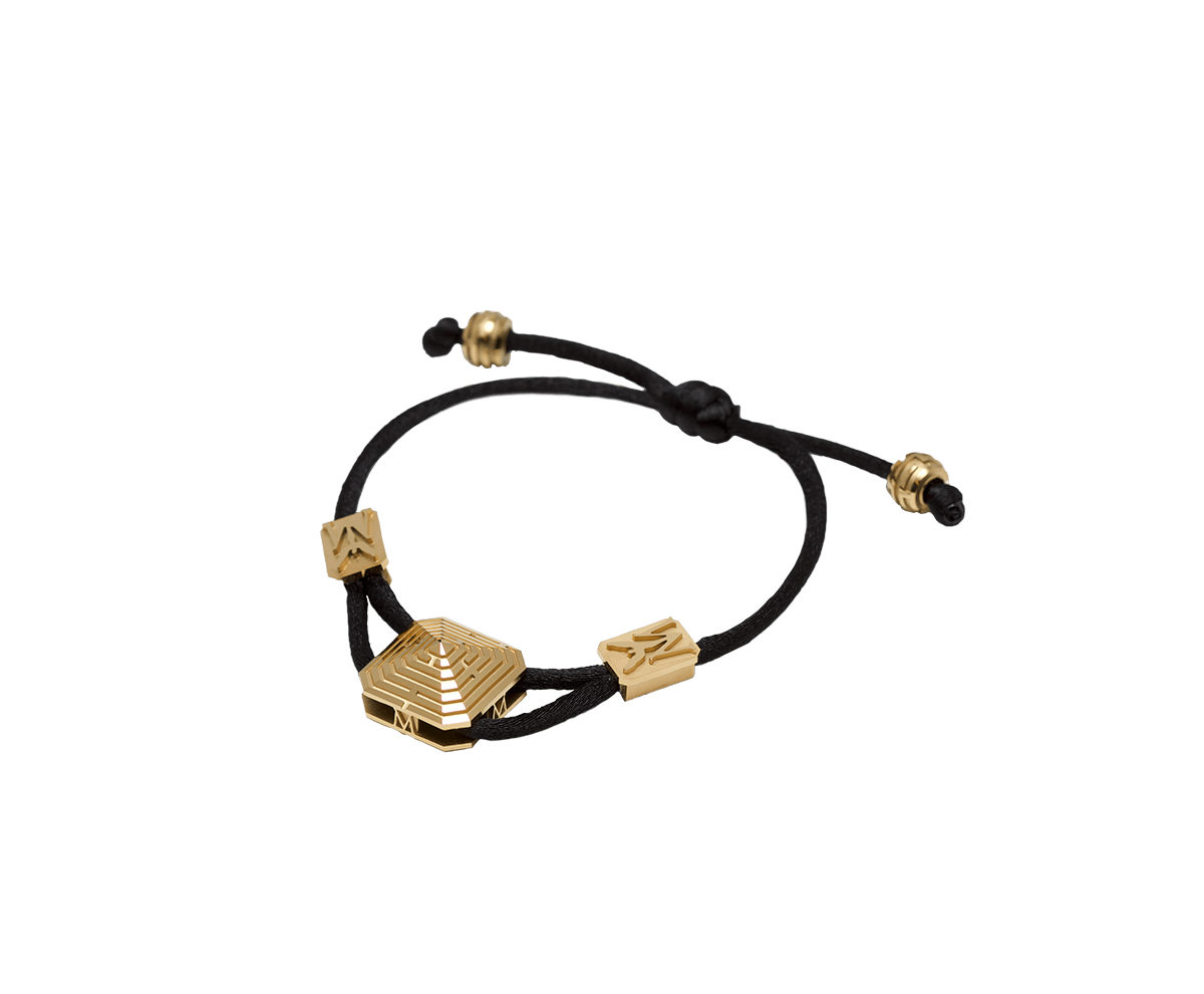 Maze Pyramid Bracelet finished in Yellow Gold. Carved in ceramics. Black thread.