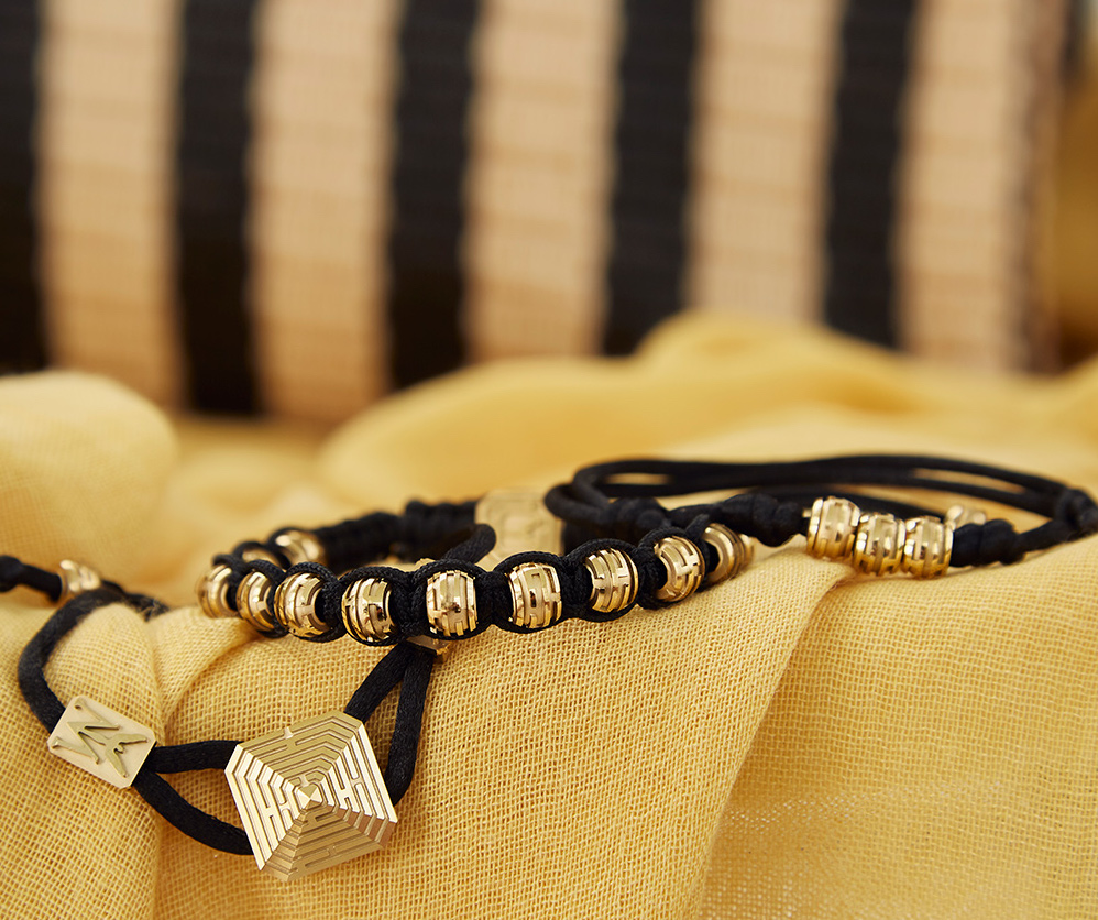 Maze Pyramid Bracelet finished in Yellow Gold. Carved in ceramics. Black thread.