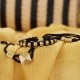 Maze Earth Bracelet finished in Yellow Gold. Carved in ceramics. Black thread.
