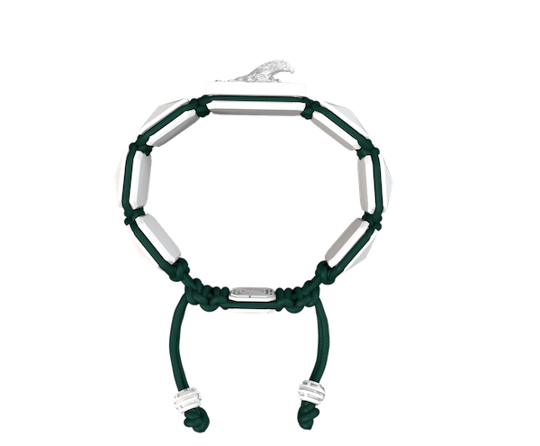 Shop I'm Different bracelet with white ceramic and sculpture finished in a Platinum effect complemented with a dark green coloured cord.